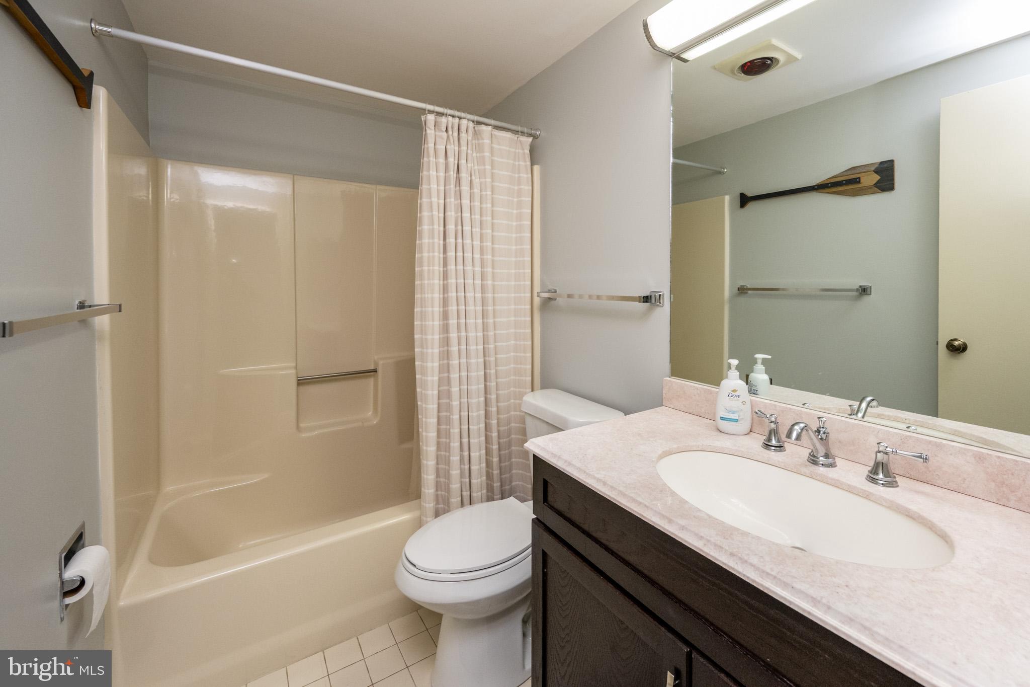 48 Bright Passage, Unit 5B McHenry, MD 21541 - Photo 29 of 56 a bathroom with a granite countertop sink toilet and shower