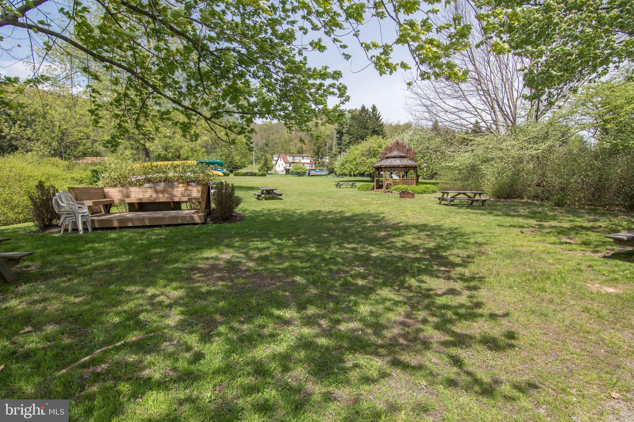 48 Bright Passage, Unit 5B McHenry, MD 21541 - Photo 44 of 56 a backyard of a house with table and chairs