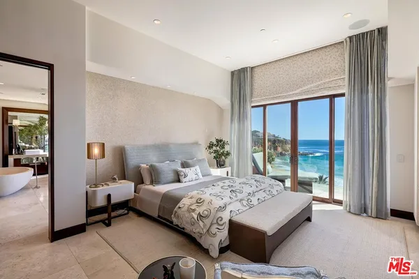 a bedroom with a bed and a large window