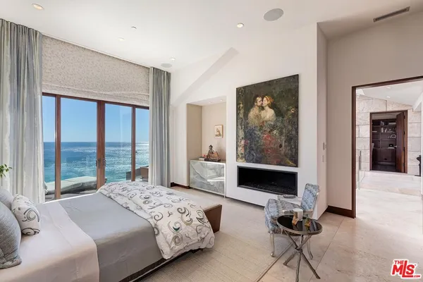 a bedroom with a bed and glass windows