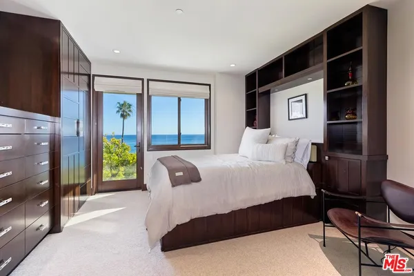 a bedroom with a bed dresser and a window