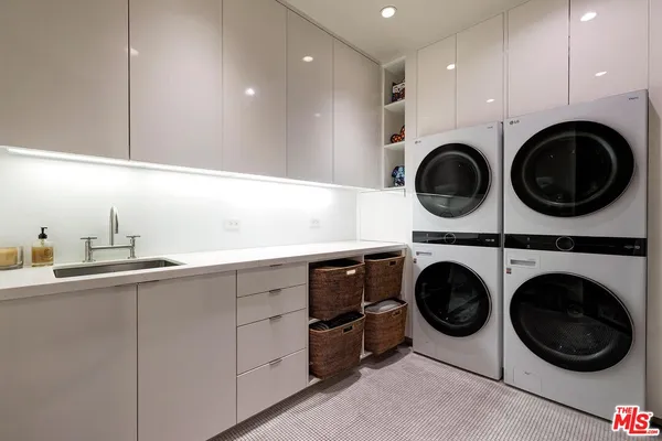 a utility room with sink dryer and washer