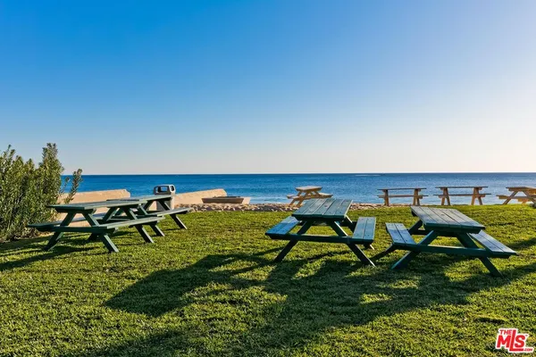 a view of a swimming pool with an outdoor seating and a yard