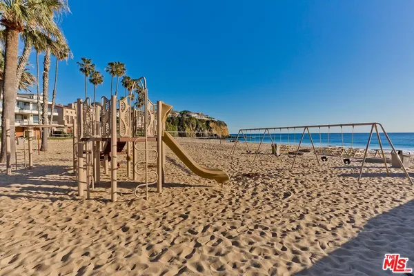 a view of a city street lined with buildings and trees