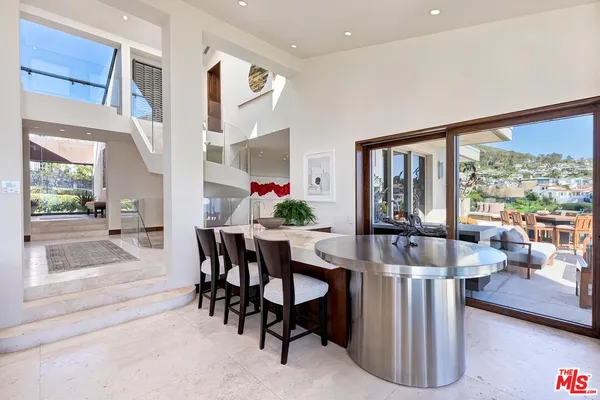a view of a dining room with furniture large windows and wooden floor