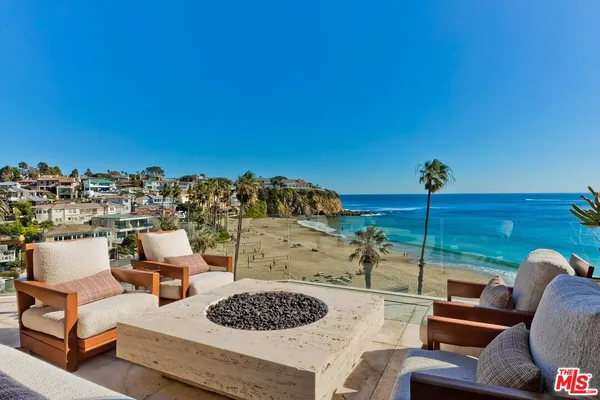 a view of a terrace with couches and sky view