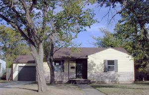 4609 Parker Street Amarillo, TX 79110 - Photo 1 of 1 a front view of a house with a yard