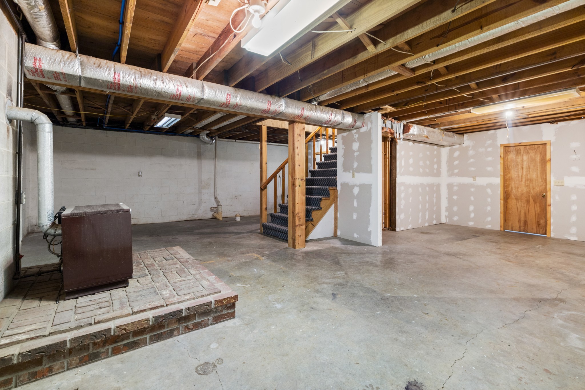 111 Rae Lane Dickson, TN 37055 - Photo 30 of 39 The basement area features a closed off area with a place to hook up your own wood burning or gas stove. Plumbing is also in place to install a bathroom! (Stove pictured does not stay with the home)