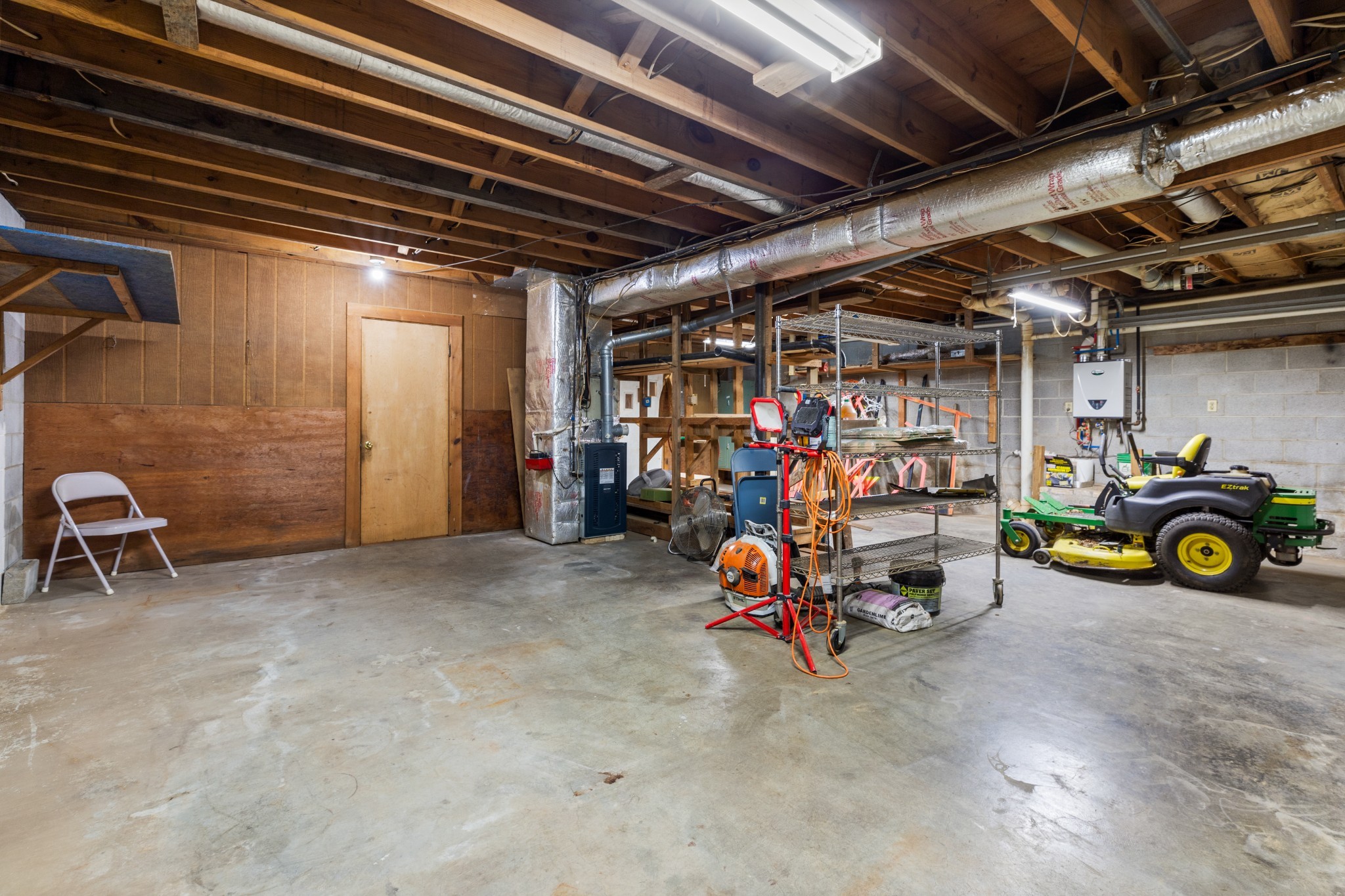 111 Rae Lane Dickson, TN 37055 - Photo 33 of 39 On the other side of the garage you will find access to the outside with a garage door to pull your car, lawnmower, etc into storage and out of the elements!