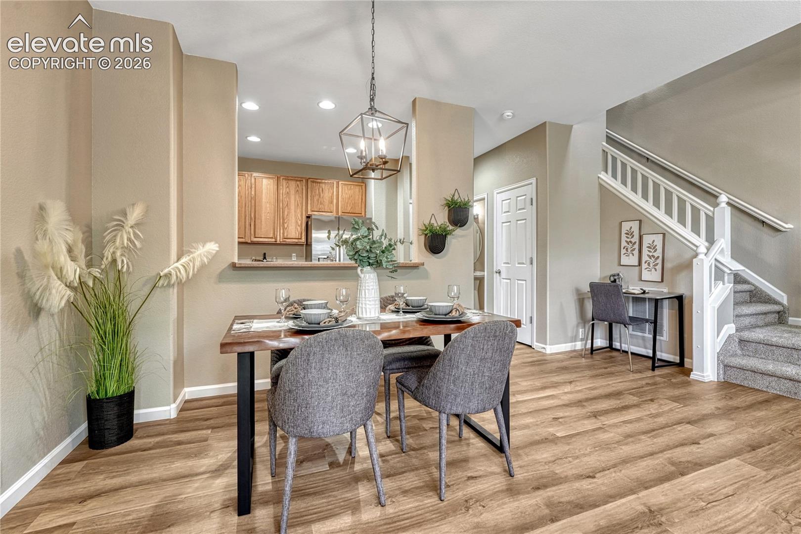 4147 Diamond Ridge View Colorado Springs, CO 80918 - Photo 9 of 42 A modern, striking geometric chandelier adds a touch of designer elegance to this dining space