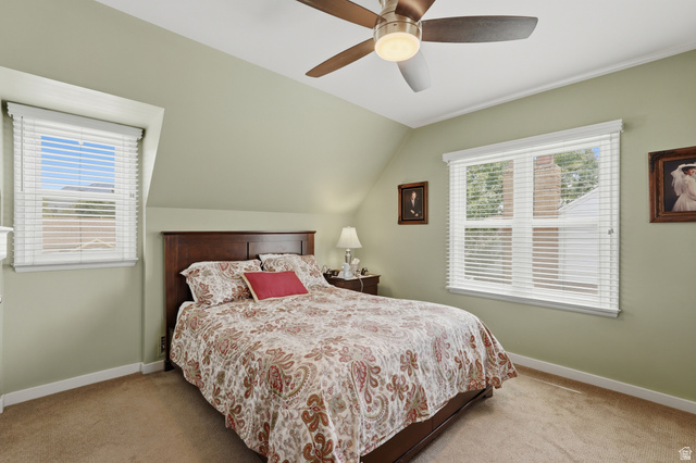 7576 South Jefferson Street Midvale, UT 84047 - Photo 28 of 53 Bedroom featuring a ceiling fan, two windows with white blinds, and light green walls