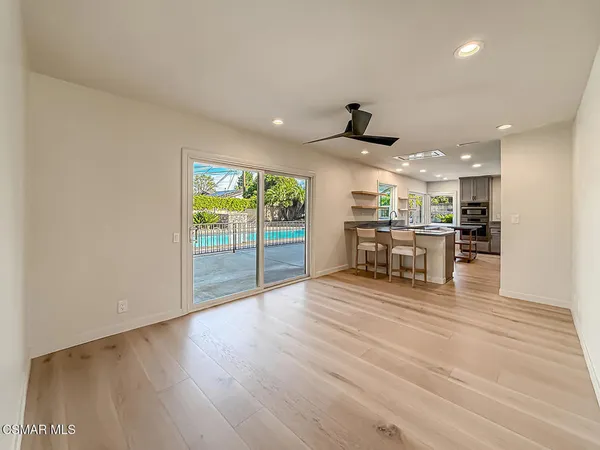 a kitchen with kitchen island a table and chairs in it