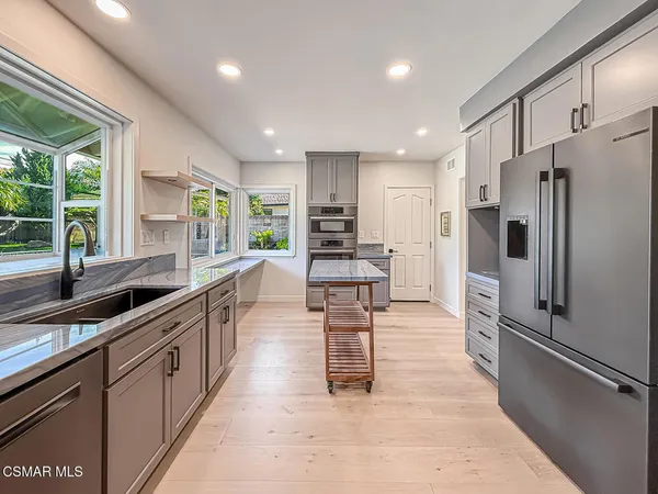 a kitchen with cabinets and stainless steel appliances