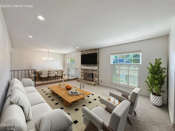 a living room with furniture a flat screen tv and a large window