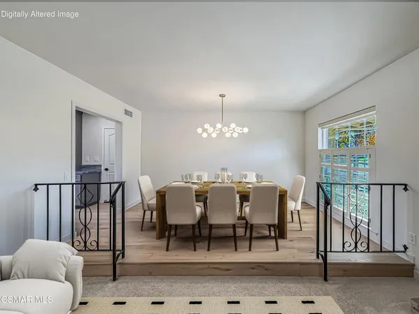 a view of a dining room with furniture and chandelier