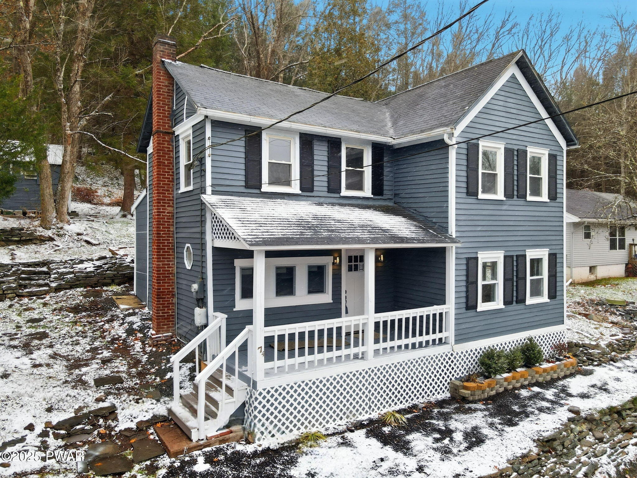 74 Charles Street Hawley, PA 18428 - Photo 35 of 40 a view of a brick house with a yard