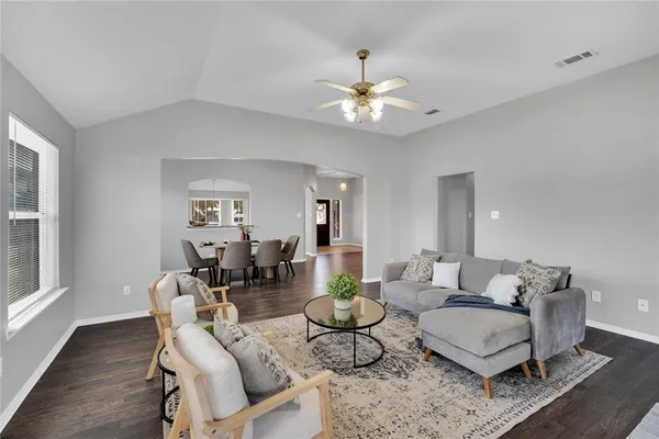 a living room with furniture and wooden floor