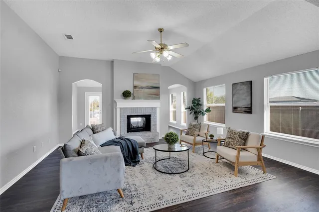 a living room with furniture a fireplace and a table