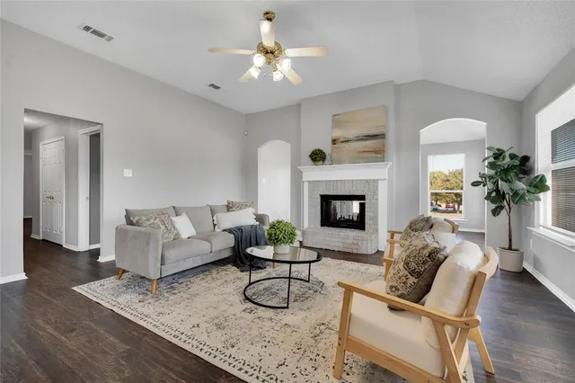 a living room with furniture and a fireplace