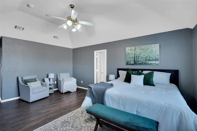 a bedroom with bed and a chandelier