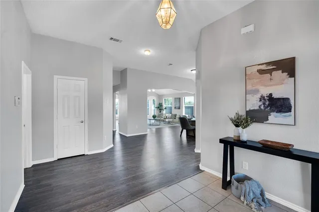 a view of an entryway with wooden floor