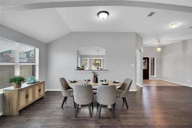 a view of a dining room with furniture and wooden floor