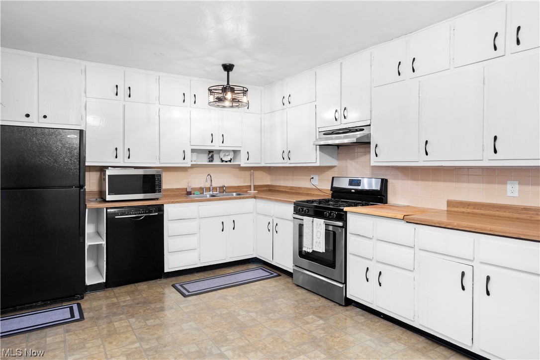 387 Fairfax Road Vermilion, OH 44089 - Photo 12 of 35 Kitchen with backsplash, white cabinets, light countertops, black appliances, and light tile flooring