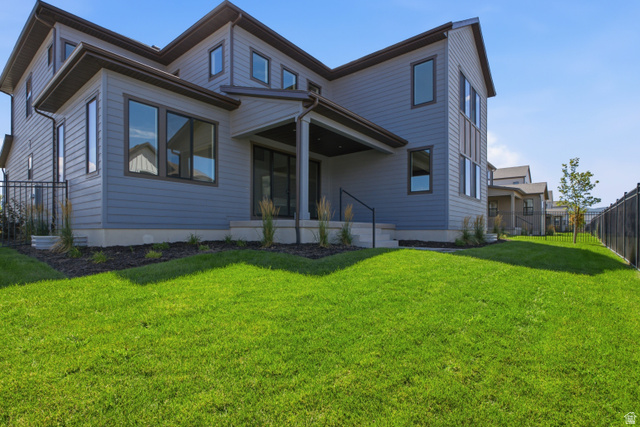 Expansive lawn area with a black metal fence