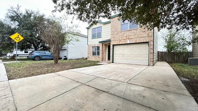 a backyard of a house with fountain and barbeque oven