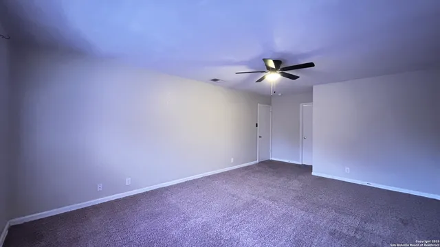a bathroom with a toilet a sink a mirror and vanity