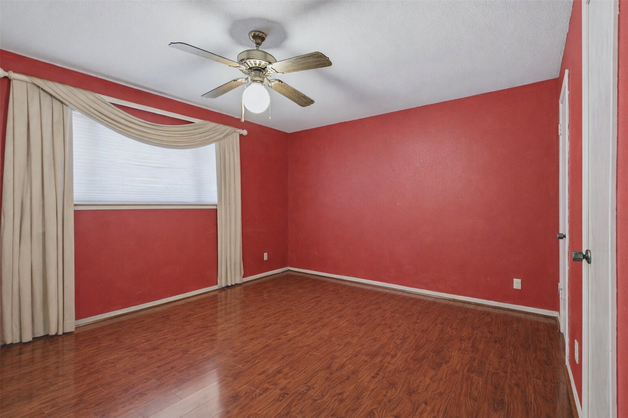 17011 Kings Walk Lane Houston, TX 77070 - Photo 17 of 50 an empty room with a window and a fan