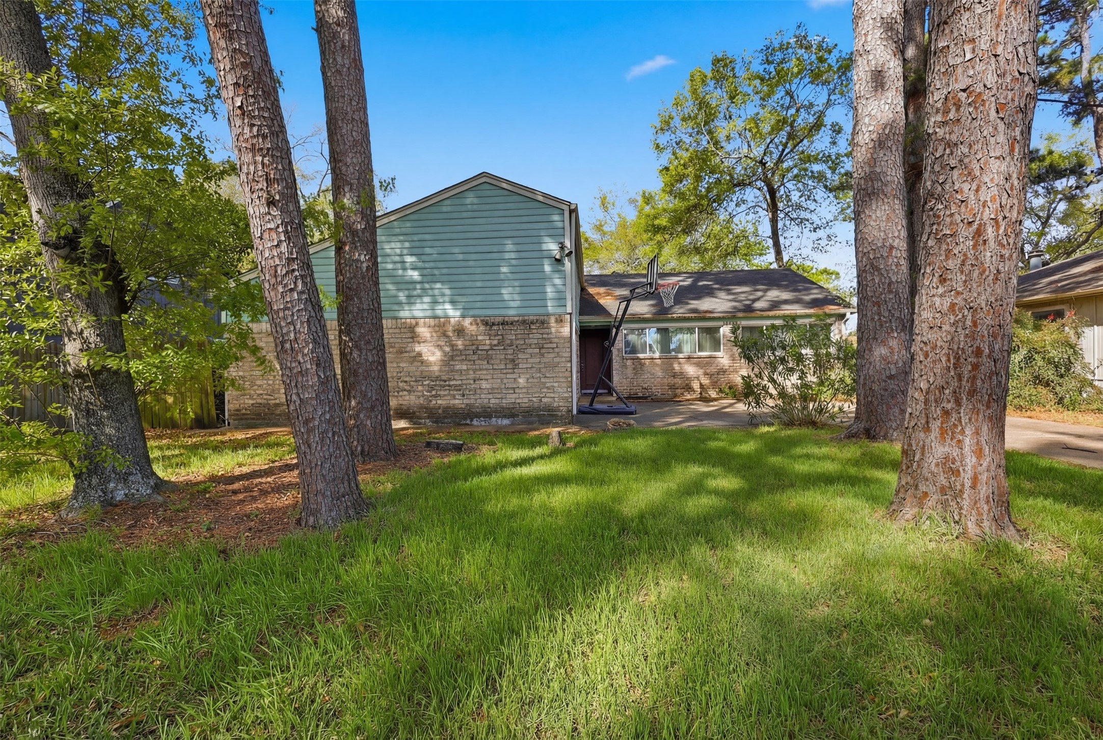 17011 Kings Walk Lane Houston, TX 77070 - Photo 4 of 50 Private backyard surrounded by mature trees, providing a peaceful outdoor retreat.