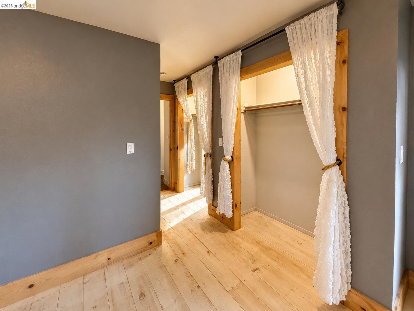 20663 Ferretti Road Groveland, CA 95321 - Photo 24 of 41 Hardwood flooring, gray wall finish, natural wood trim, and closet storage with hanging rod