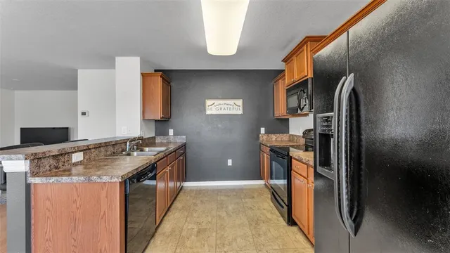 a kitchen with stainless steel appliances granite countertop a stove and a sink