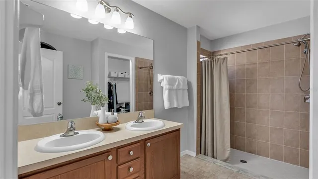 a bathroom with a sink double vanity and a mirror