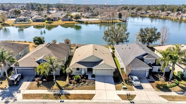 an aerial view of a house with lake view