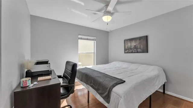 a bedroom that has a bed and a desk in it