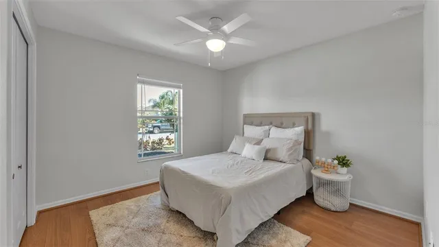 a bed sitting in a bedroom next to a window