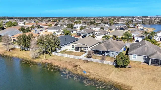 an aerial view of residential houses with outdoor space and river