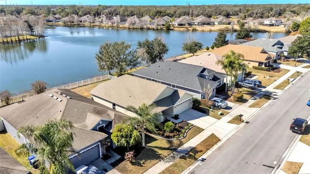 an aerial view of a house with a lake view