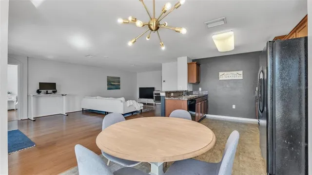 a living room with furniture a fireplace and a view of kitchen