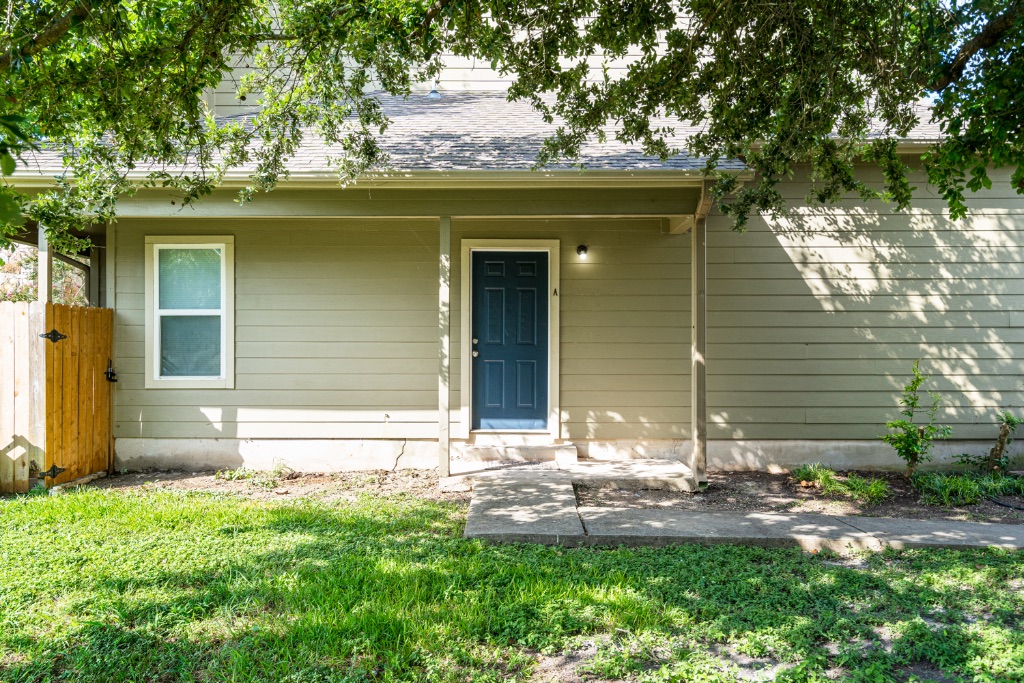 8703 Schick Road, Unit A Austin, TX 78729 - Photo 1 of 21 a front view of a house with a yard