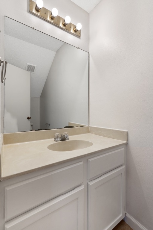 8703 Schick Road, Unit A Austin, TX 78729 - Photo 11 of 21 a bathroom with a sink and a mirror