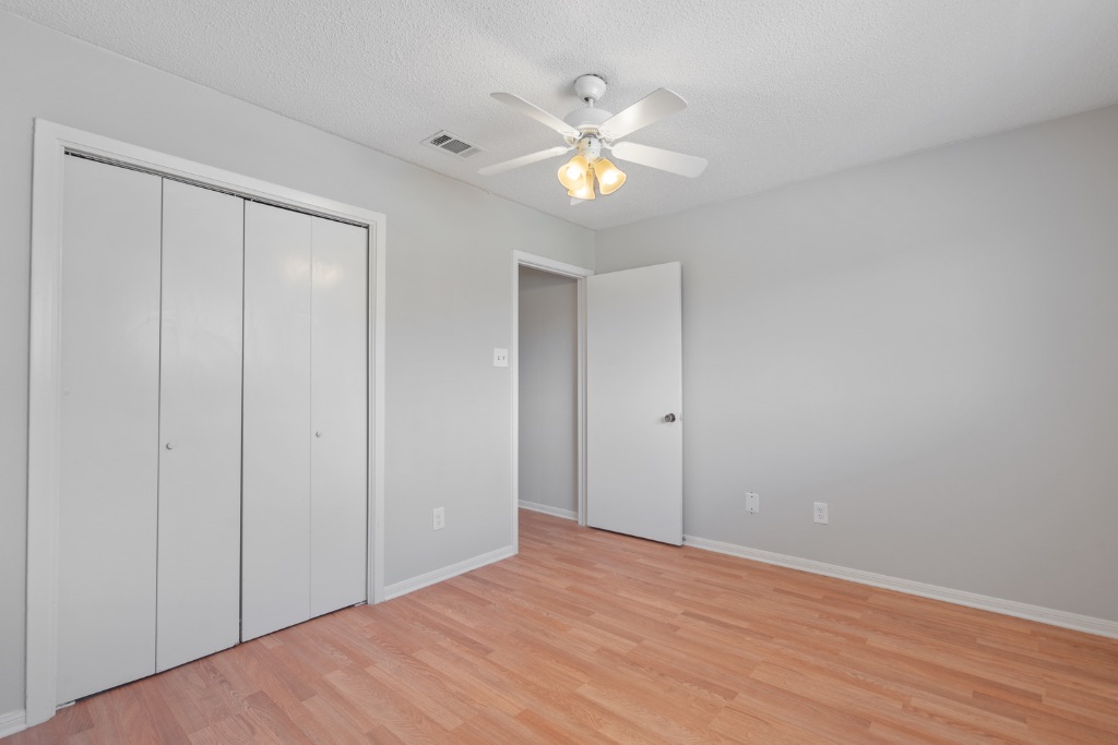 8703 Schick Road, Unit A Austin, TX 78729 - Photo 13 of 21 a view of an empty room with wooden floor