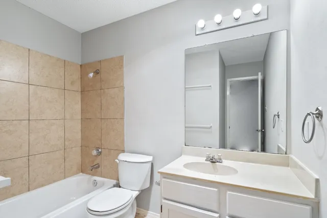 a bathroom with a sink toilet vanity and shower