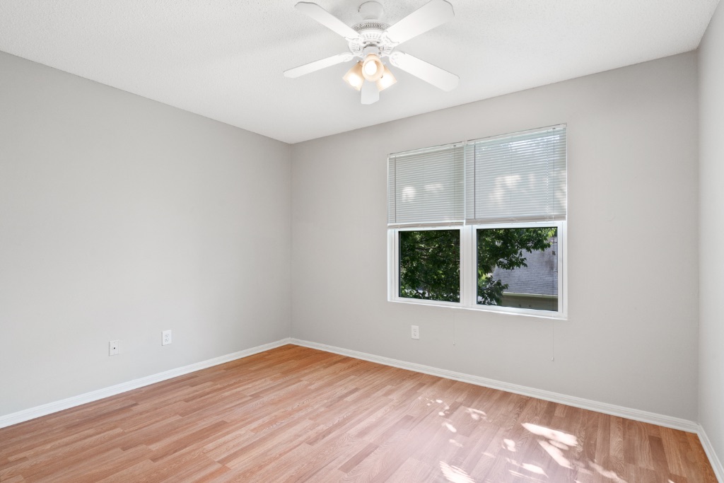 8703 Schick Road, Unit A Austin, TX 78729 - Photo 15 of 21 wooden floor in an empty room with a window