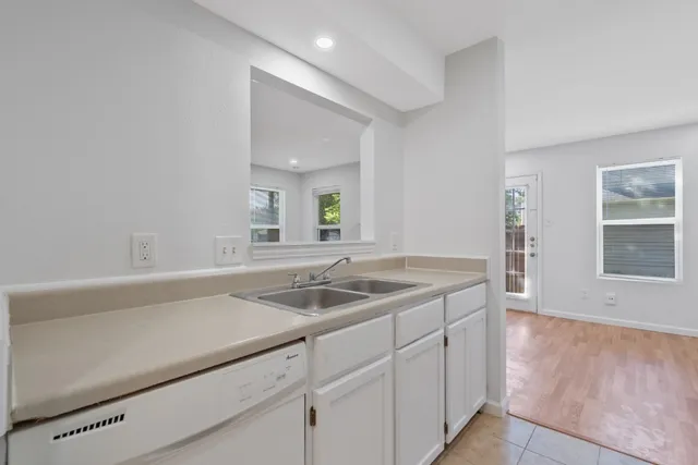 a kitchen with a sink and cabinets