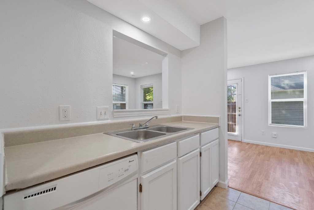 8703 Schick Road, Unit A Austin, TX 78729 - Photo 9 of 21 a kitchen with a sink and cabinets