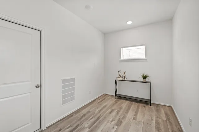 a view of room with wooden floor