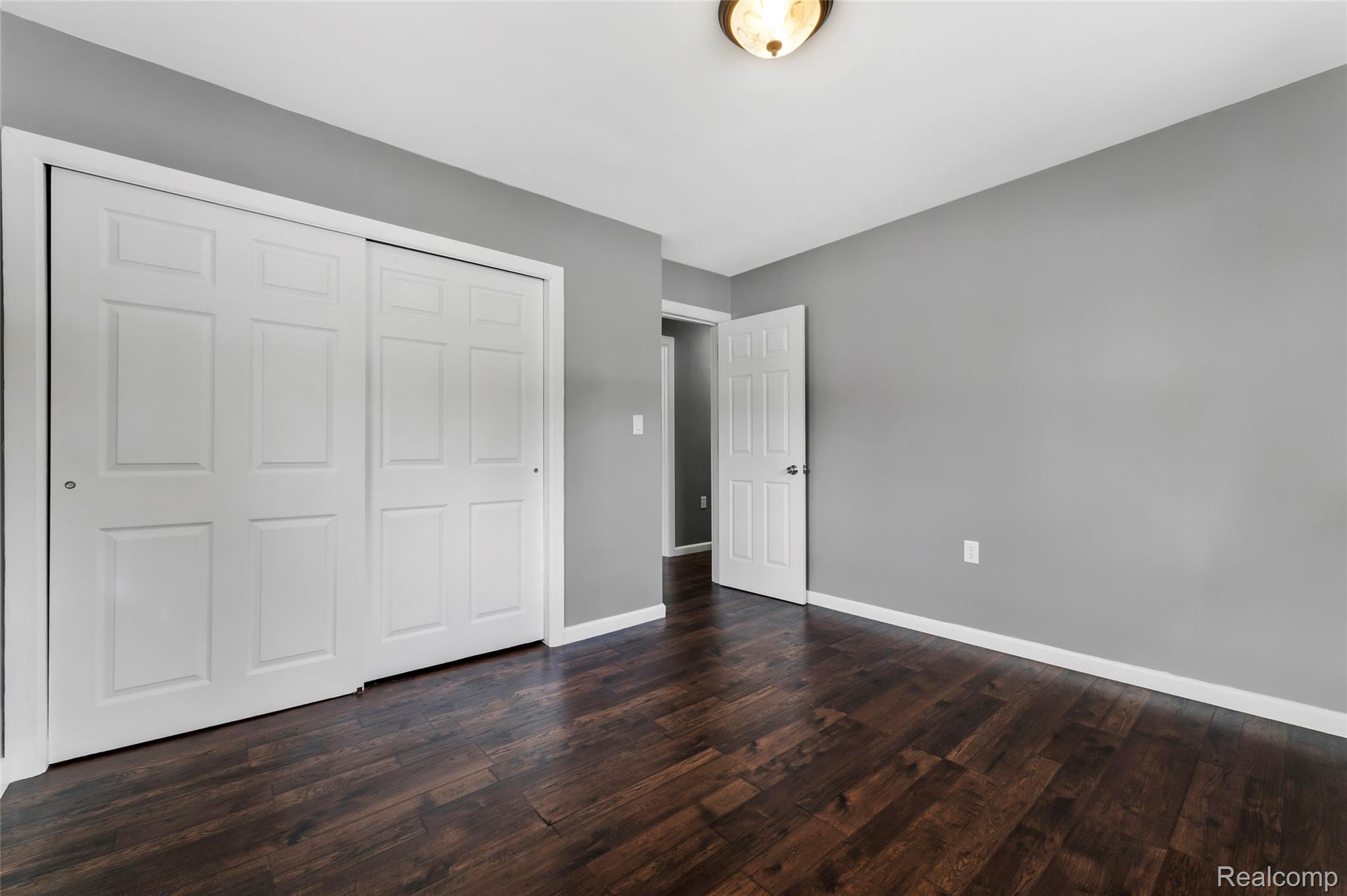 13515 Lenmoore Road Belleville, MI 48111 - Photo 21 of 41 Unfurnished bedroom featuring a closet and dark wood-style floors